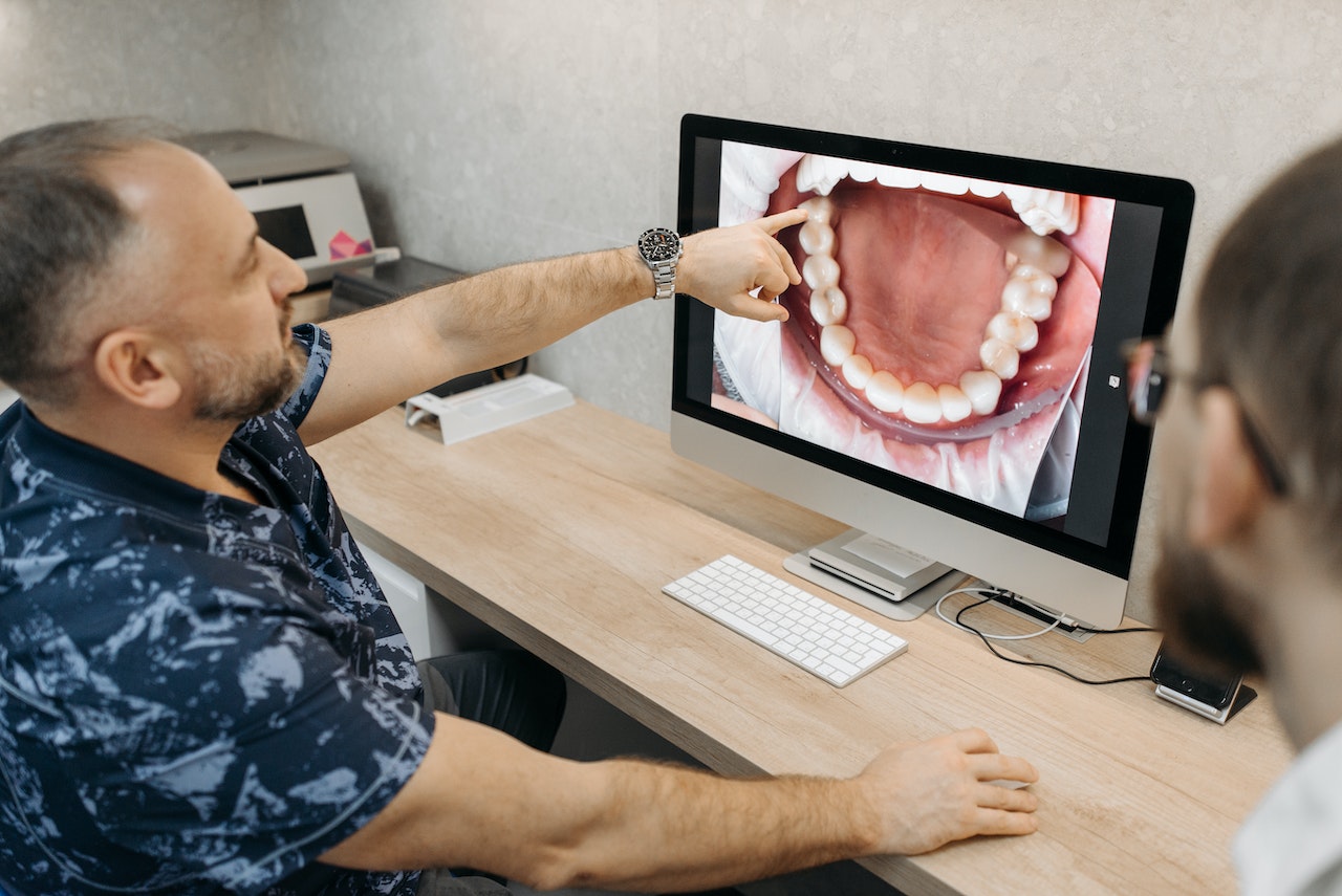 dentist showing patient picture of teeth